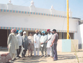 Members of the Trust point out the place where a well belonging to the poets house was filled up.