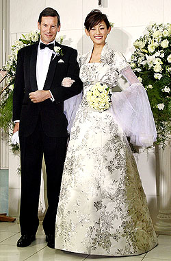 Japanese actress Asami Ishikawa shows off a platinum-made wedding dress, Platinum White, with Platinum Guild International CEO James Courage at a press preview at a Tokyo hotel on Wednesday. The textile was woven with platinum strings and platinum beads. The $1.7-million dress was designed by Japanese designer Keiji Tagawa for the promotion of platinum jewellery