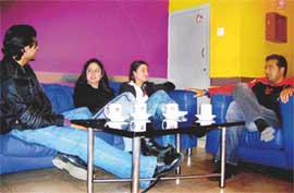 Lounging around:The city youngsters sit relaxed in a lounge over a hot cuppa (top) and a  family has a luxurious lunch at Orchid lounge (bottom)