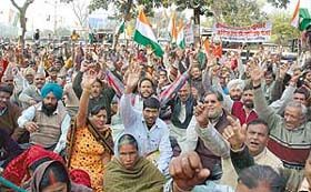 Workers of the Indian National Trade Union Congress stage a dharna at the DC's office in Ludhiana