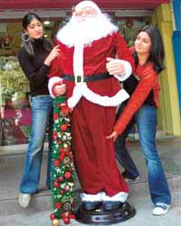 JINGLE BELLS: These young ladies help old Santa stand on his feet.