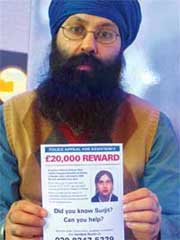 Surjit Athwals brother Jagdeesh holds out the poster announcing a reward of 20,000.