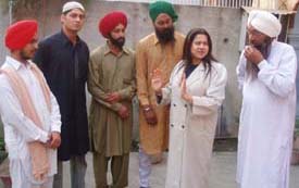 Film actress Preeti Sapru explains a scene to local artistes in Mandi Ahmedgarh on Friday
