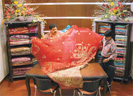 WEDDING RHAPSODY: Hitesh Gulati proudly displays a bridal lehenga at the recently added designer floor of Gulati Editions.