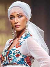 A model presents a wedding creation of Ana M. Cortes, called Gitanas (Gypsys), as part of the new designer contest at a fashion show during a wedding fair in Seville on Friday night.