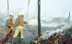 Firemen at the site of the fire.