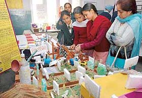 Students and teachers admire a model put up during state level science exhibition being held at Atam Public School