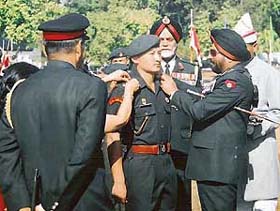 Gen J.J. Singh performs the pipping ceremony on Gentleman Cadet Penjor Gyspsen of Bhutan at the IMA passing-out parade in Dehra Dun