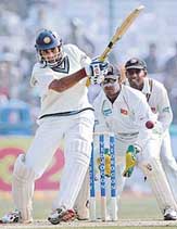VVS Laxman plays a shot as Sri Lankas wicketkeeper Kumar Sangakkara and Thilan Samaraweera look on during the first day of the second Test in New Delhi on Saturday.