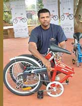 Mr Sandeep Shridhar, Brand Manager, TI Cycles of India, displays the first folding cycle BSA Foldman in Bangalore on Sunday.