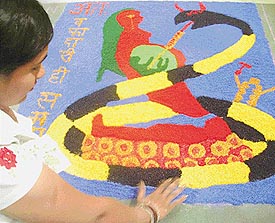 A girl makes a rangoli at an inter-college competition on AIDS awareness and human rights at the Shivalik Institute of Education and Research, Mohali, on Saturday.