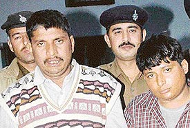 Murder accused Mewa Ram and Sucha in police custody at the crime branch office in Sector 11 of Chandigarh on Sunday.