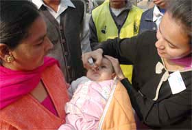 A volunteer administers polio drops to an infant during the nationwide Pulse Polio Drive in Jalandhar