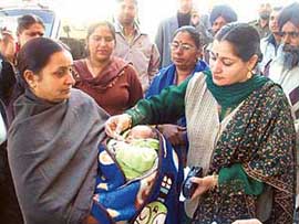 Dr Indu, SDM of Malerkotla, administers polio drops to a child at Ahmedgarh.