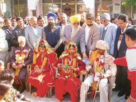 Leaders and volunteers bless newly wedded couples at Ahmedgarh.