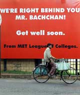 A delivery man cycles past a hoarding put up for Amitabh Bachchan in front of a hospital where he is recuperating from bowel surgery in Mumbai on Sunday