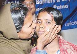 Gudia Khatun, a 13-year-old girl from Gaya district in Bihar, who will represent India at the UNICEF Global Event in London, is hugged by her mother in Patna