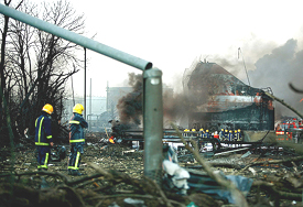 Firefighters get to work as smoke billows from an oil depot fire near Hemel Hempstead, southeast England, on Monday.