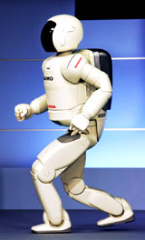 Honda Motor Companys new humanoid robot ASIMO jogs during a demonstration at Hondas Tokyo head office on Tuesday