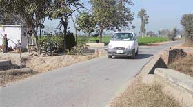 A bridge without sidewalls situated close to a crossing on the Dehlon-Pakhowal road near Jartoli village