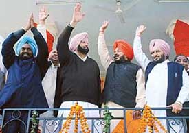 Punjab Chief Minister Capt Amarinder Singh, PPCC president Shamsher Singh Dullo, All-India Bazigar Sabha president Sadhu Singh Dharamsot and Power Minister Lal Singh wave to the crowd at a rally in Patiala on Tuesday.