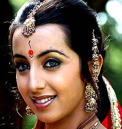 A model wears a analog integrated circuit with intelligent charging capabilities for lithium-ion batteries pasted on a bindi during a launch ceremony in Bangalore on Wednesday