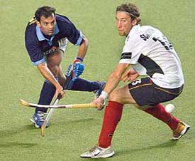 Viren Rasquinha (left) flicks the ball past Germanys Justus Scharowsky during their Champions Trophy match in Chennai on Wednesday. 