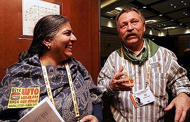 French farmer Jose Bove (right) gestures as he talks to the Press along with Indian NGO representative Vandana Shiva after handing over a basket of organic vegetables to the Deputy Director- General of the WTO during a protest against genetically modified crops in Hong Kong on Wednesday