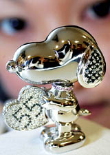 A platinum Snoopy figurine, encrusted with black, white and pink diamonds, is displayed at a Tokyo departmental store on Thursday