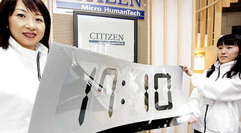 Japans Citizen watch employees display a prototype of the worlds first flexible digital clock in 3mm thickness