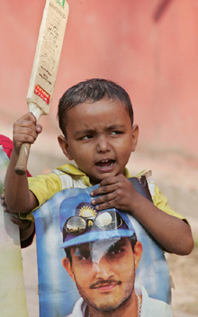 A boy holds a poster of Sourav Ganguly during a protest in Kolkata on Thursday.