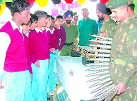 School students look at ammunition during an army weapons and equipments exhibition organised by Vajra Corps in Jalandhar on Friday.