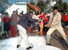 Visitors enjoy throwing artificial snow at each other at the launch of ice game at Funcity near Ramgarh