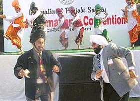 Dr S.S. Ahuja from the USA and Mr G.S. Sawhney dancing along with artistes at a cultural function organised for the members of the International Punjabi Society at PCA stadium, Mohali