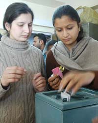 Girls cast their vote for the panchayat poll in the Totu area, near Shimla, on Sunday.
