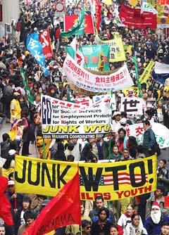 Demonstrators march peacefully to protest against World Trade Organisation (WTO) talks after a night of street battles between protesters and the police through Hong Kong on Sunday. 