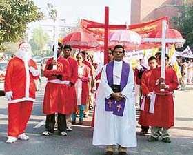 Father Daniel Gill leads the Christmas procession from the Sarabha Nagar church on Sunday morning