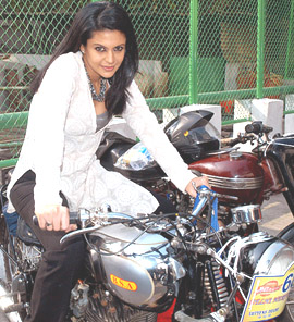Mandira Bedi poses for photographers at the inauguration of the Delhi Heritage Car and Motorcycle Rally in New Delhi on Sunday.
