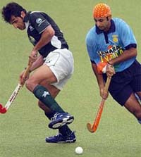 Prabhjot Singh runs past Pakistans Muhammad Saqlain during a Champions Trophy classification match for the fifth place in Chennai