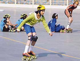 A skater performs while others get ready for their turn during a skating championship being held at Panchkula