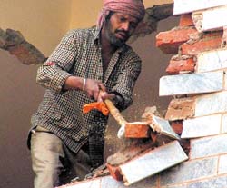 An illegal structure being demolished at a house in West Patel Nagar in the Capital