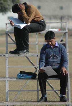 TAKING THE TEST THE HARD WAY: Two students review their notes before the start of an examination