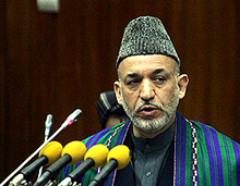 Afghan President Hamid Karzai addresses Parliament members during its opening session in Kabul on Monday