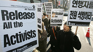South Korean protesters shout slogans at a rally demanding the release of South Korean demonstrators who were arrested during the WTO rally in Hong Kong, in front of the Chinese Embassy in Seoul on Monday