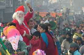 A man dressed as Santa Claus waves during a Christmas procession in Jalandhar on Tuesday. 