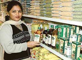  A home maker happily flaunts her favourite brand of olive oil at Bhatia Supermarket