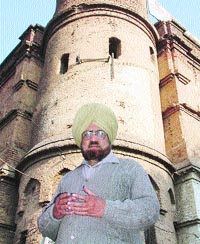 Punjabi poet Parminderjit stands outside his publication office.