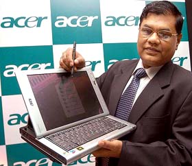 Mr W.S. Mukund, Managing Director, Acer India, displays a TravelMate C202, a tablet PC featuring a biometric fingerprint security, at a press conference in Bangalore on Wednesday