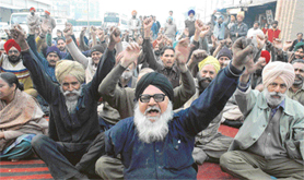 Employees of PRTC protest against non-fulfilment of their demands near the bus stand in the Ludhiana on Wednesday.