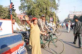A traffic policewoman directs traffic in Patna